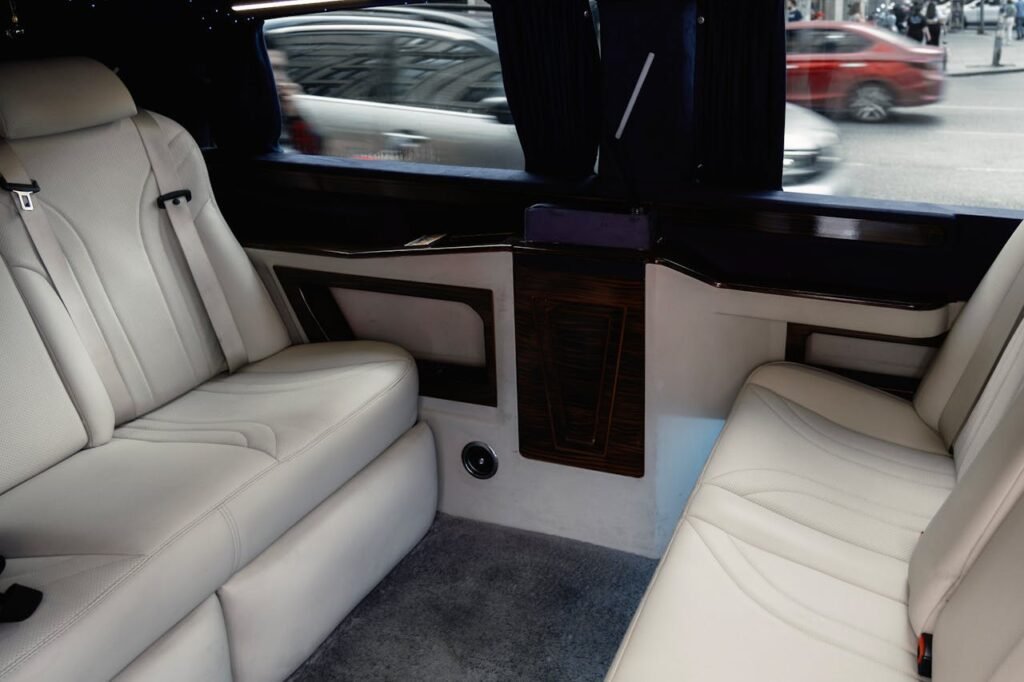 pexels photo 17455628 Interior view of a luxury limousine showcasing white leather seating with stylish design and amenities.